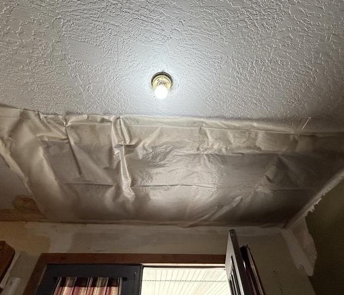Water damaged ceiling that has been partially treated during water damage restoration project