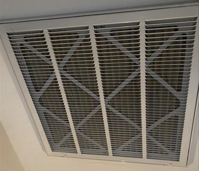 AC filter cover showing how dust collects as air is being pulled in